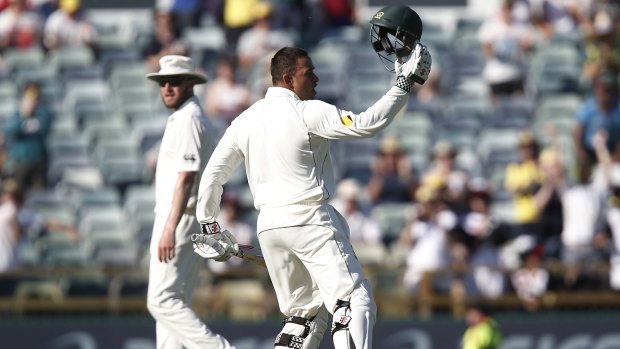 Usman Khawaja ackowledges the crowd after reaching three figures.
