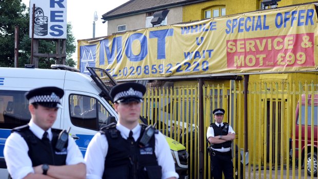 Police stand guard on Ripple Road in east London, where officers conducted raids after Saturday's deadly terror attack.