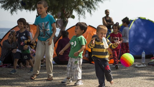 Migrant boys play on a beach on Kos.