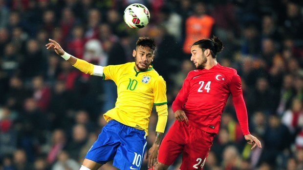 Neymar flies for the ball with Turkey's Tarik Camdal.