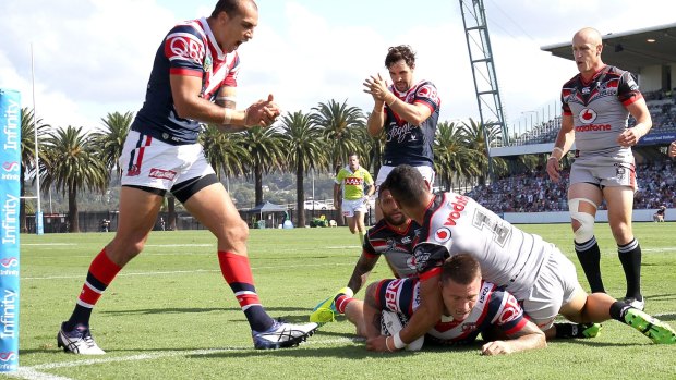 Try-time: Shaun Kenny-Dowall crosses the stripe in the Roosters' defeat to the Warriors on Sunday.