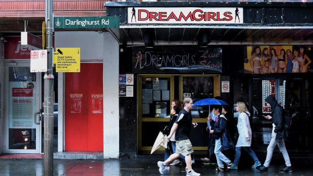 People walk past the entrance to DreamGirls on Darlinghurst Road in Kings Cross, Sydney. 