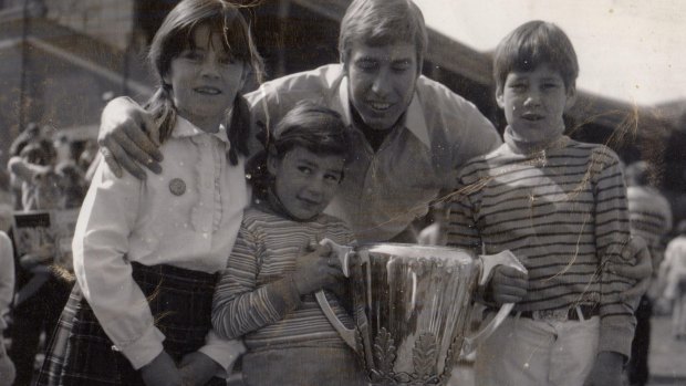 Caroline Wilson with sister Amelia, brother Will, Bill Barrot and the Richmond 1969 premiership cup.