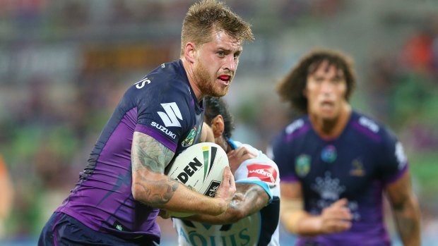 Storming home: Cameron Munster breaks through a Gold Coast tackle.