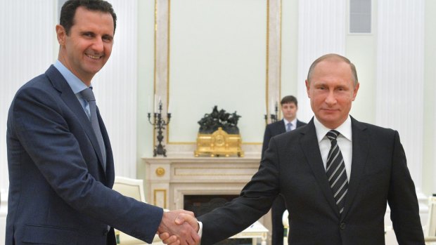 Moscow meeting: Syrian President Bashar al-Assad (left) shakes hands with Russian President Vladimir Putin at the Kremlin.