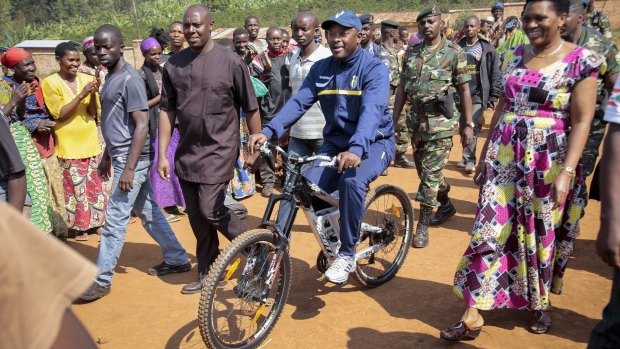 President Pierre Nkurunziza rides a bicycle to cast his vote in the presidential election, which he won, in July last year. Violence has flared since he earlier announced  his intention to stand for a third term.