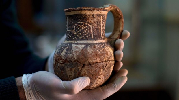 Jihad Abu Kahrlah, an archaeologist at Syria's National Museum, holds an artefact rescued from the Daraa Museum in Damascus before Islamic State looters could get it.