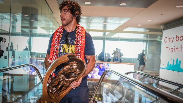 Spoils of victory: Johnathan Thurston prepares to take the NRL premiership trophy home to Townsville for the first time.