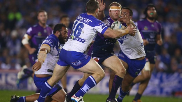 Ryan Hinchcliffe of the Melbourne Storm is tackled by the Canterbury Bulldogs 