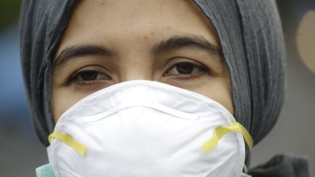 An Indonesian activist wears a mask during a protest demanding the government take quick action to suppress the haze from wildfires in Sumatra and Borneo.