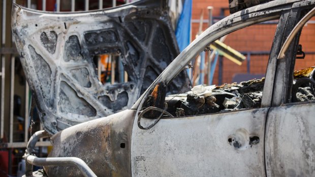 A burnt-out car in Fisher on Wednesday morning after the shooting overnight.