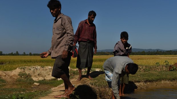 Four Rohingya men flee the violence in Myanmar by crossing to Bangladesh in November.