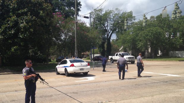 Baton Rouge police officers patrol a road block in Baton Rouge after colleagues were shot on Sunday.