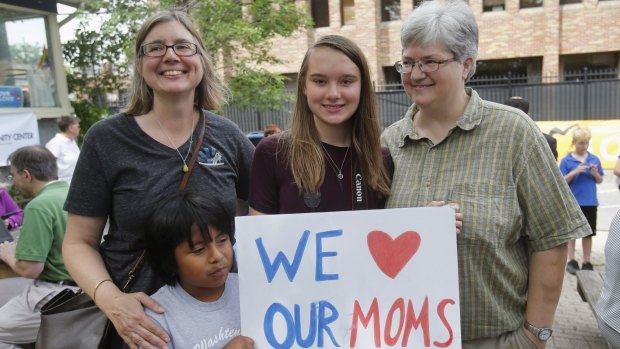 Beth Sherman (left) and her wife Karen Hawver (right) celebrate with their children Ben and Emma (centre) the US Supreme Court's landmark ruling of legalising gay marriage nationwide, at a rally in Ann Arbor, Michigan.