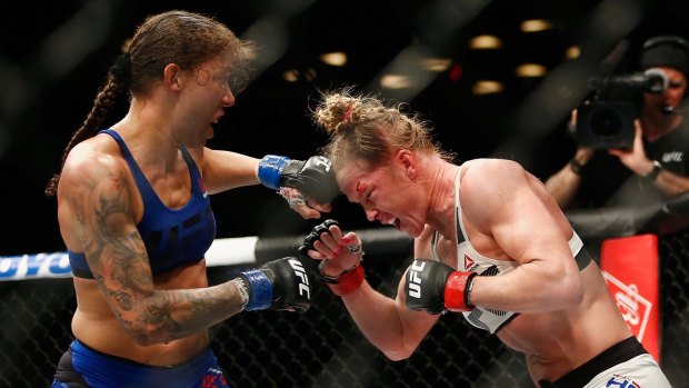 Germaine de Randamie throws a punch against Holly Holm in their UFC women's featherweight championship bout.