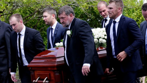 Pallbearers, including Michael Clarke and Aaron Finch, carry Phillip Hughes's coffin to the hearse.