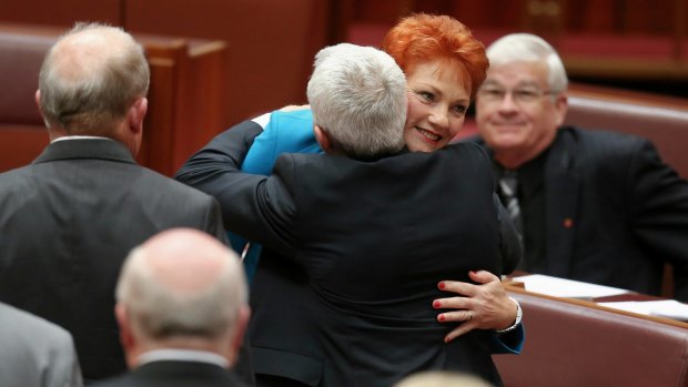 Senator Pauline Hanson is congratulated by Senator Malcolm Roberts after delivering her first speech in the Senate at Parliament House in Canberra on Wednesday 14 September 2016. fedpol Photo: Alex Ellinghausen