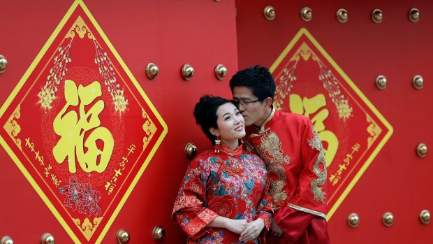 A young Beijing couple have a formal wedding portrait taken this month.