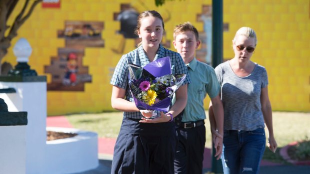 Locals leave flowers at Dreamworld on Wednesday morning.