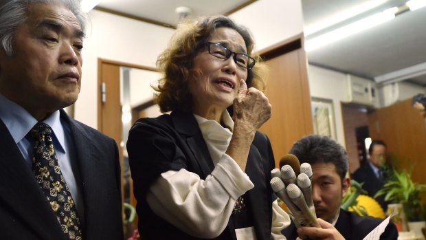 Junko Ishido, right, mother of Kenji Goto, speaks to reporters while her husband Yukio Ishido stands beside her at their home in Tokyo on Sunday.  