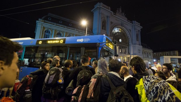 Migrants board buses bound for Austria outside Keleti station in central Budapest on September 4.