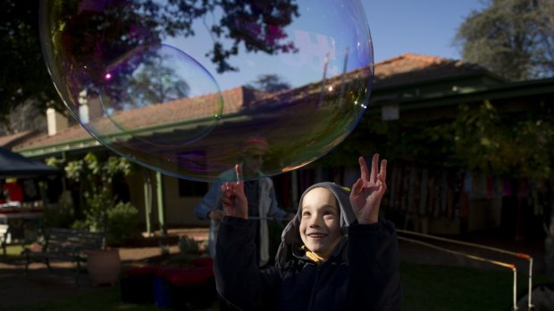 Wyatt Cheeseman, 7, plays with bubbles at the final day of Gorman House markets  on Saturday.