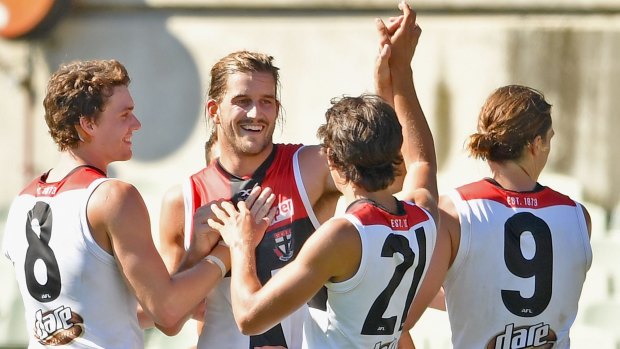 St Kilda players celebrate a goal during the preseason competition game against Carlton. 