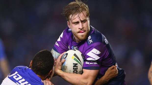 Cameron Munster of the Storm is tackled during the round 16 match against the Canterbury Bulldogs on Monday.