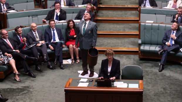 An attendant mops up a leak from the roof during question time. 