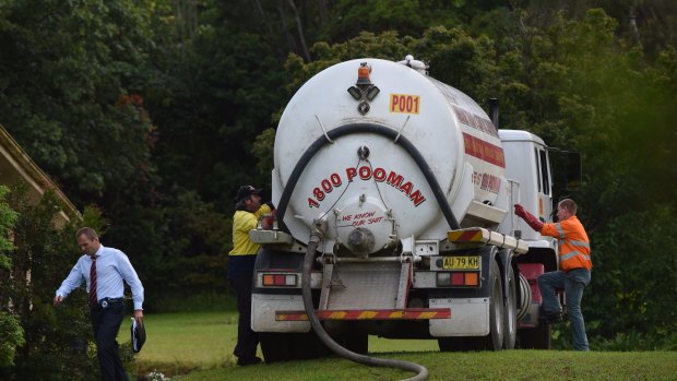 A septic service truck at the property in the search for the toddler.
