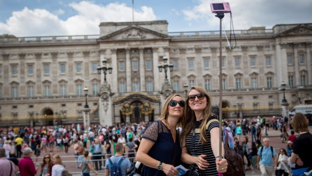 Maintenance required: Tourists take a selfie in front of Buckingham Palace.