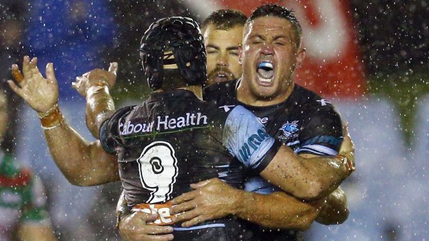 Wet and wild: Chris Heighington, Michael Ennis and Wade Graham celebrate a try against South Sydney.