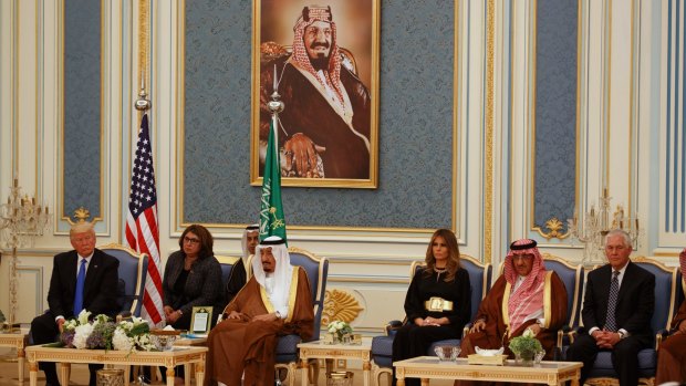 US President Donald Trump listens during the presentation ceremony for the Collar of Abdulaziz. A portrait of King Abdulaziz hangs on the wall above his son, King Salman, his grandson, Prince Mohammed bin Nayef, and US Secretary of State Rex Tillerson.