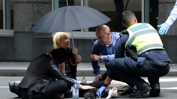 Bystanders comforted the injured in Bourke Street.