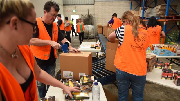 Volunteers pack hampers at Wetherill Park Foodbank.