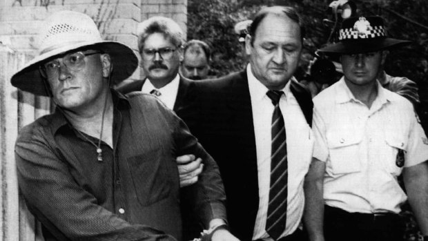 Commander Rick Ninnes leads David Eastman away from his Reid home after his arrest on December 23,  1992 for the murder of Colin Winchester. Eastman's subsequent conviction was quashed on Friday.