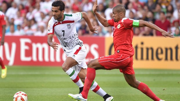 Iran's Masoud Shojaei (left) is challenged by Bahrain's Mohamed Hasan.