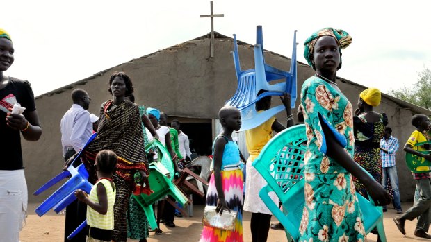 South Sudanese attend a Sunday service in Mingkaman. People bring their own chairs, a scarce commodity.