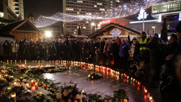 People gather at a memorial site in Berlin on Tuesday.