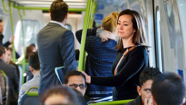 Forced to stand: Claire Denby makes her way from West Footscray to North Melbourne by train.