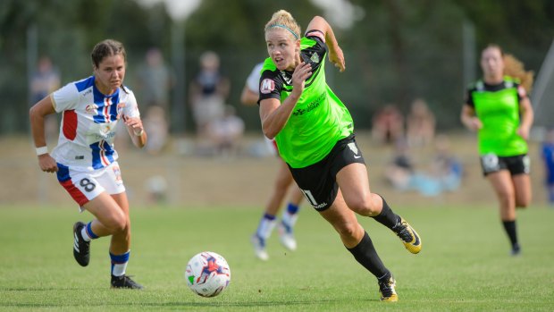Canberra United forward Elise Thorsnes gets past Newcastle Jets defender Sophie Nenadovic.