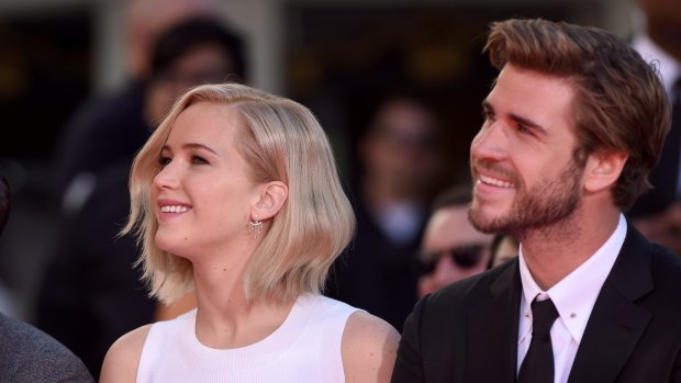 Jennifer Lawrence and Liam Hemsworth pose at <i>The Hunger Games: Mockingjay - Part 2</i> Hand And Footprint Ceremony at TCL Chinese Theatre on October 31, 2015 in Hollywood, California. 