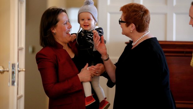 Minister for Revenue and Financial Services Kelly O'Dwyer with daughter Olivia and Defence Minister Marise Payne during the ceremony.
