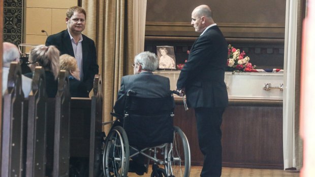 Suzanne King's brother, Robert Cooper, sits in a wheelchair at the funeral in North Ryde.
