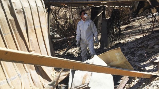 A resident walks among the ruins of his destroyed Wye River property.