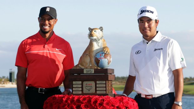Hideki Matsuyama and Tiger Woods with Matsuyama's trophy.