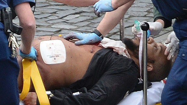 Khalid Masood is treated by emergency services outside parliament. 