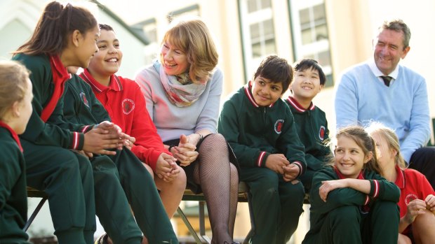 Maxine McKew, who wrote a book that examined the Australian education system, and principal John Farrell with students at Our Lady of Mount Carmel in Sydney's inner west last year. 