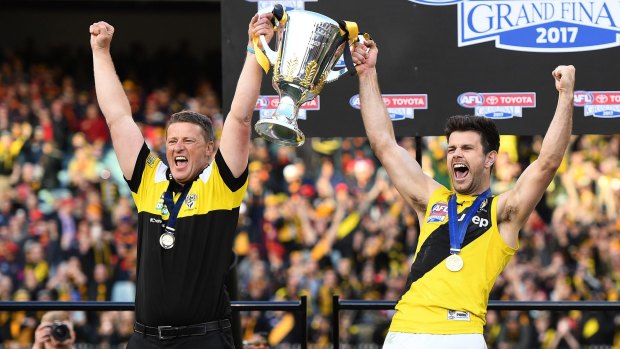 Damien Hardwick and Trent Cotchin celebrate with the premiership cup.
