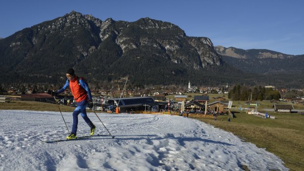 A ski mountaineer ascends a slope of man-made snow at Garmisch Classic Ski resort in the German Alps.